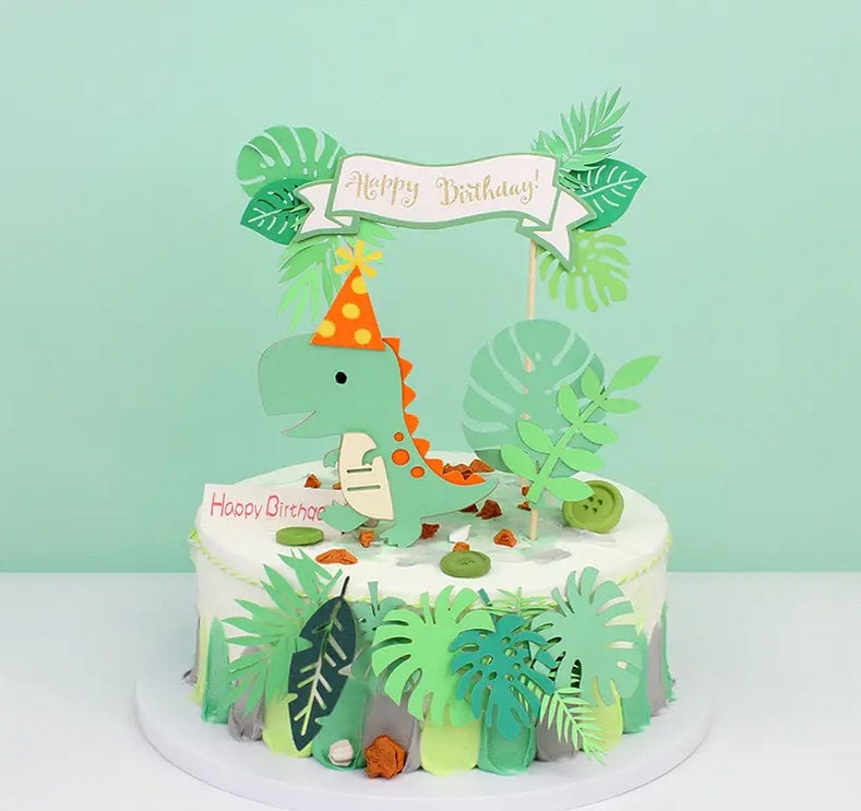 Dinosaur Jungle Theme Birthday Cake Topper Set - Green & Orange Dino with Party Hat, Tropical Leaves - Kids Party Decorations